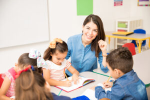 <profesora-infantil-sonriente-con-alumnos>