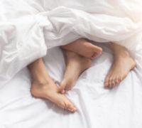 Young couple man and woman intimate relationship on bed feet